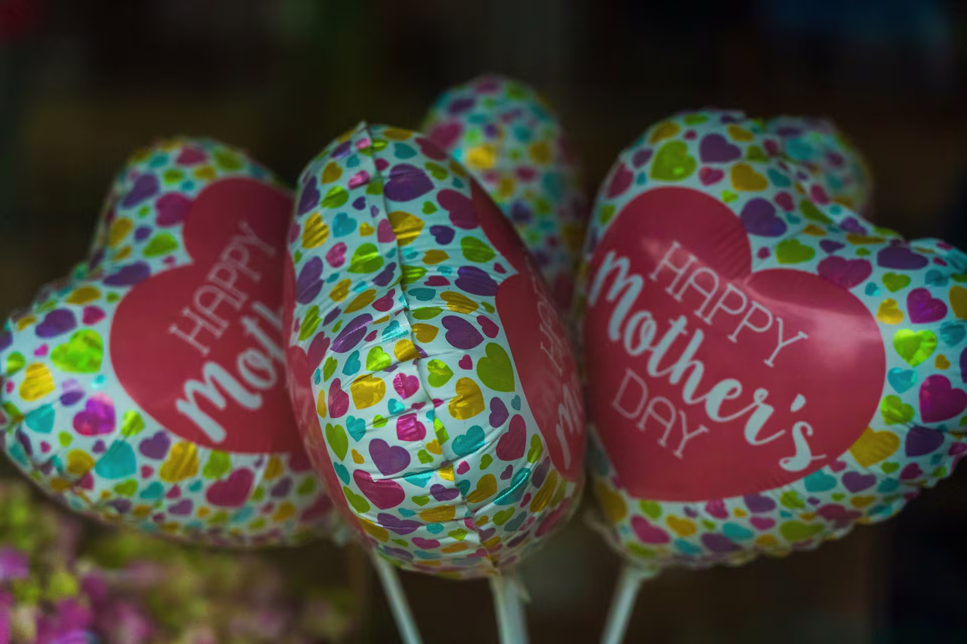 Heart-shaped balloons that say "Happy Mother's Day"