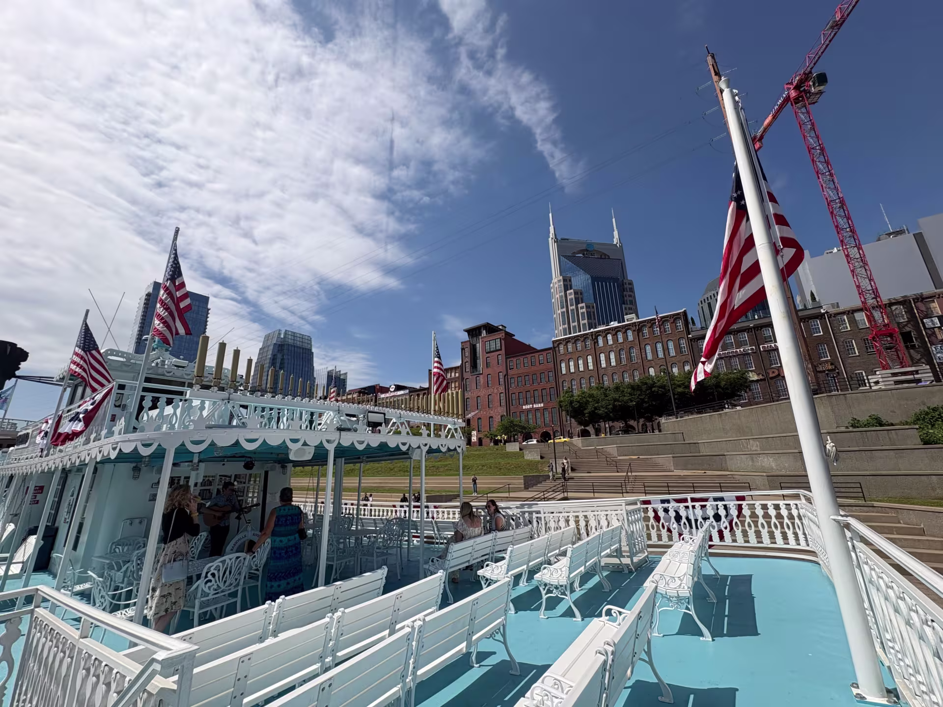 Downtown Nashville from the deck of a blue and white riverboat.
