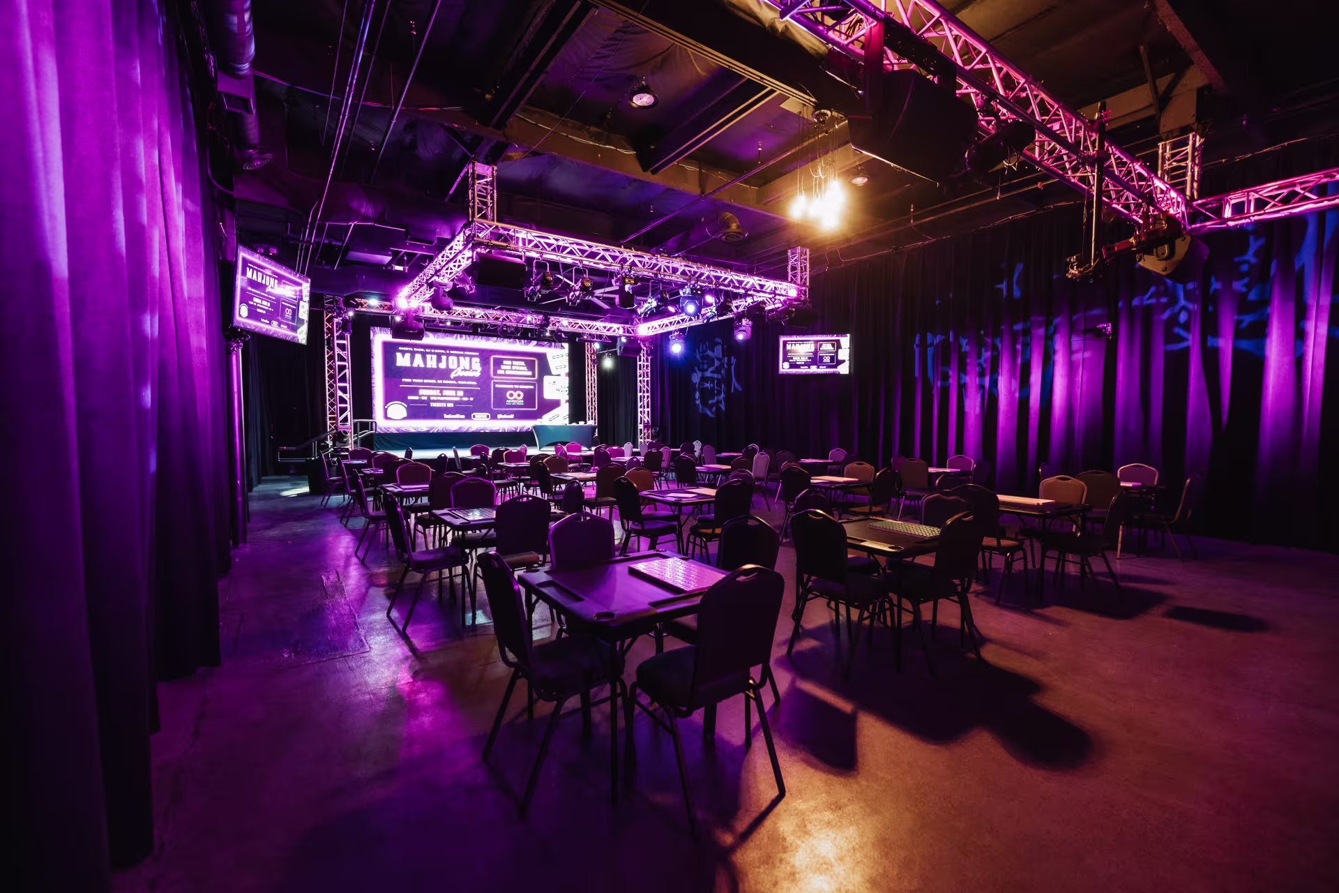 An event space for mahjong with purple lights.