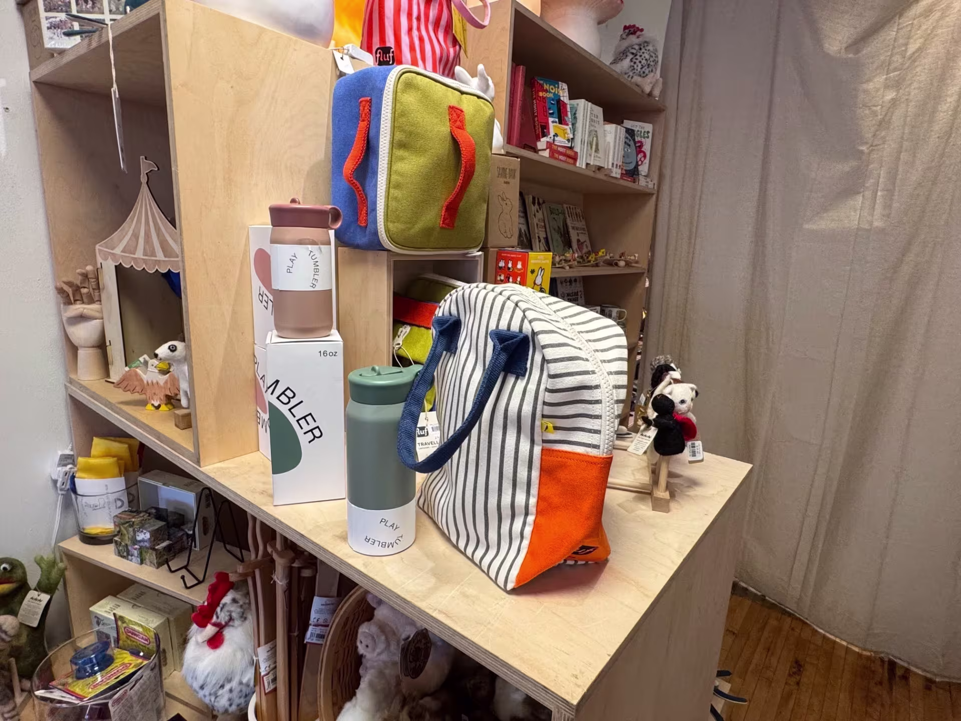 Interior of store with various colorful home goods on display on wooden shelving