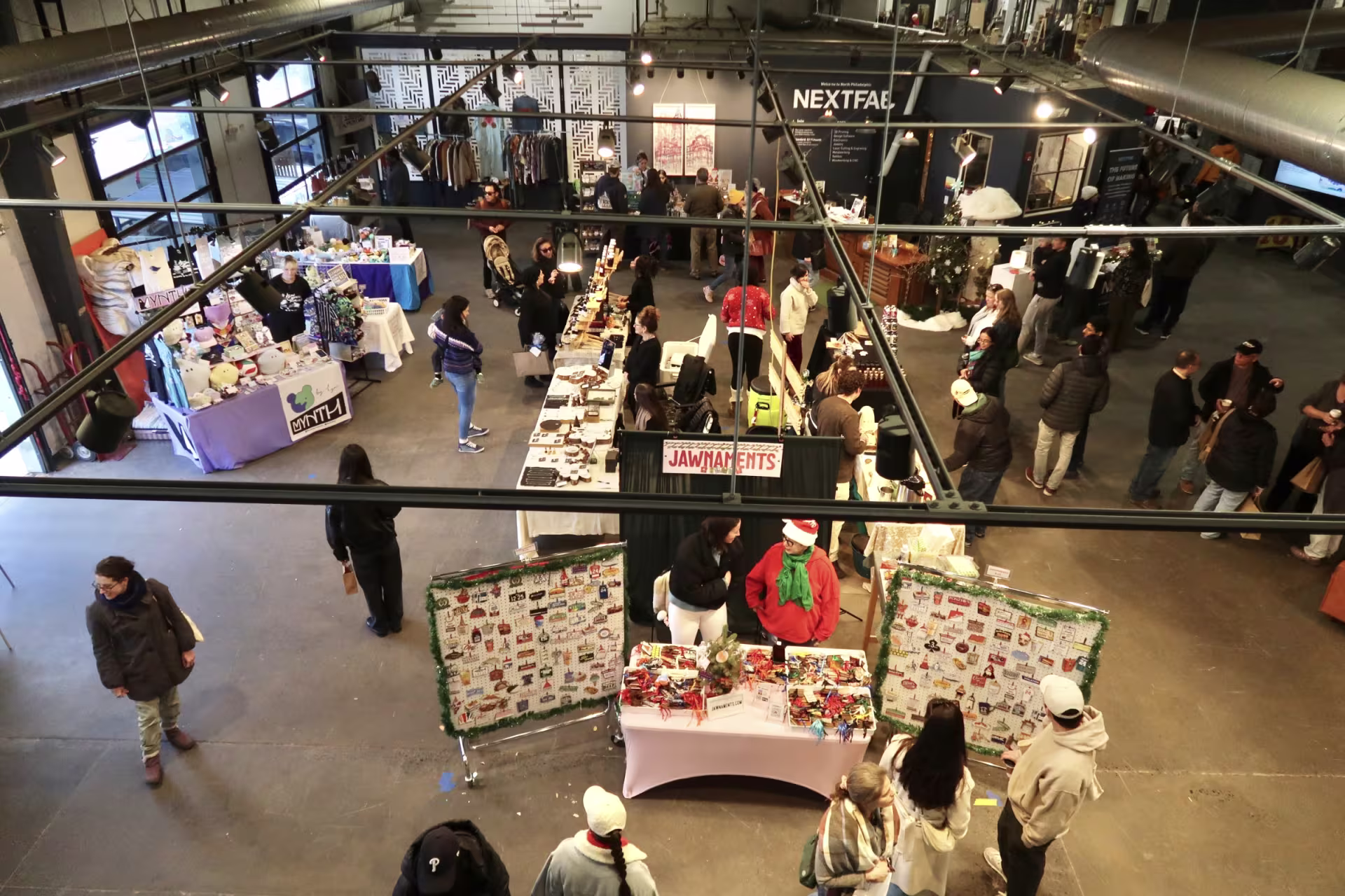 Shoppers walk around a warehouse during a holiday market.