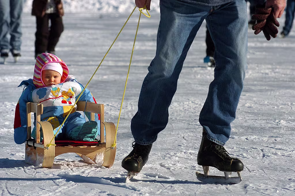 One-year-old Lizzy Lawson gets a ride from her grandpa at the Evergreen Lake skating rinks.