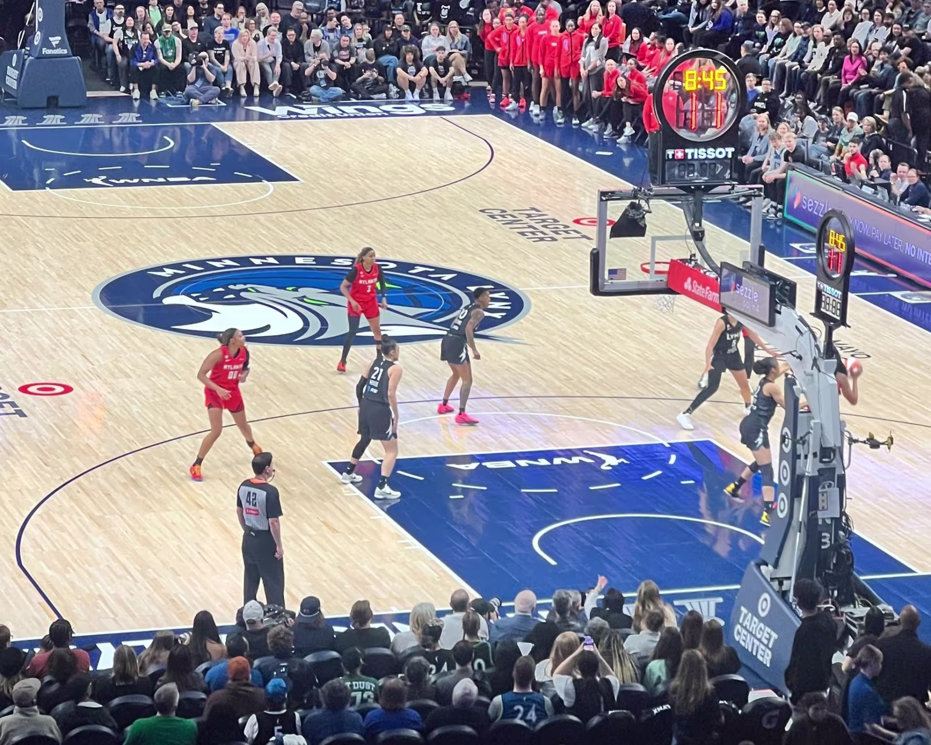 Professional women's basketball game in play, as viewed from audience in arena