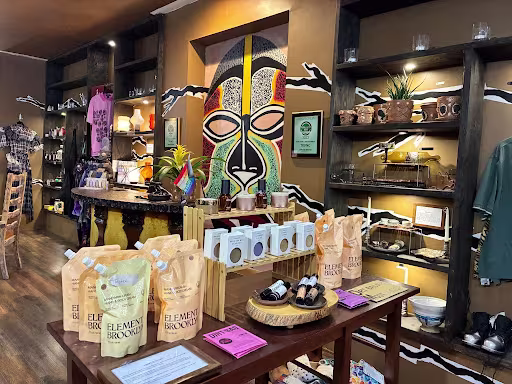 Items for sales on tables and shelves at Trunc. There's a yellow, green, and red mural in the middle of the wall at the center.