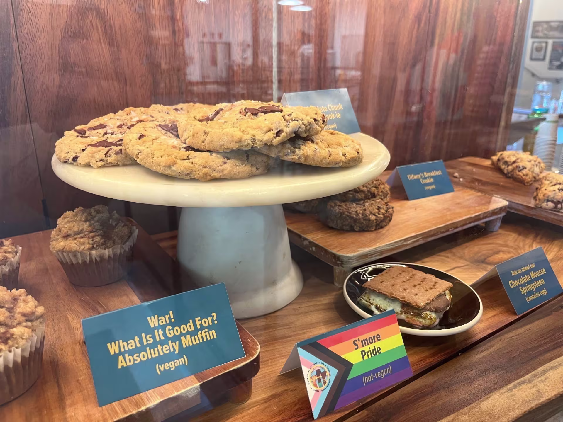 A tray of cookies, below the tray are an assortment of muffins and smores