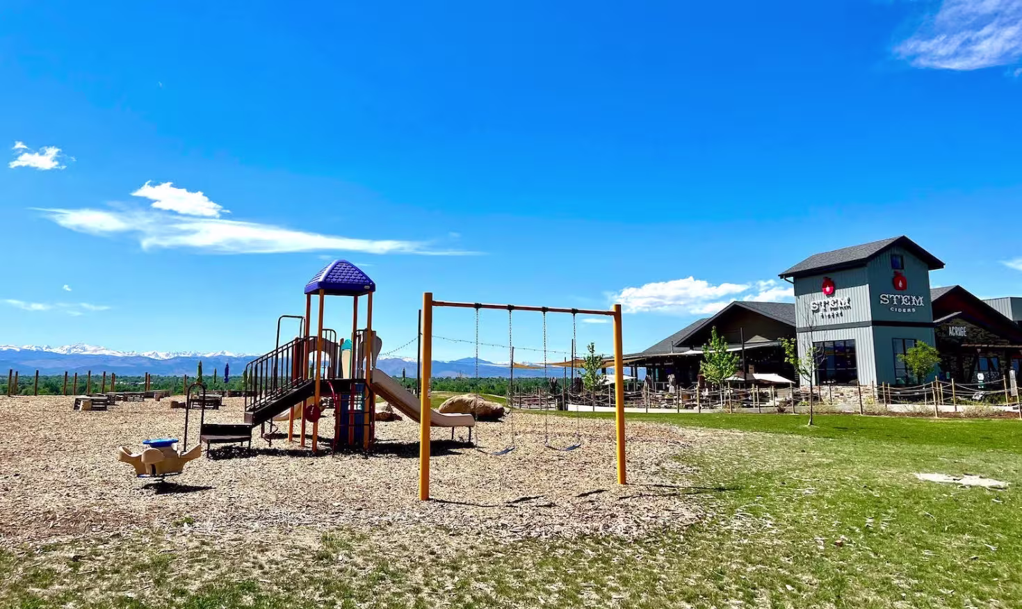 Outdoor cidery with playground and green grass