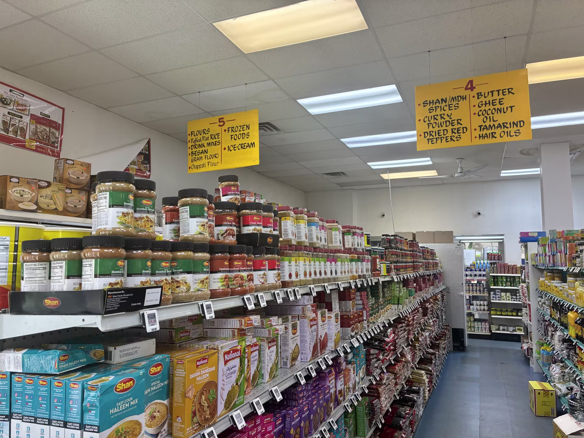 Grocery aisles at International Foods & Spices in University City, showcasing spices, oils, flours and butters. 