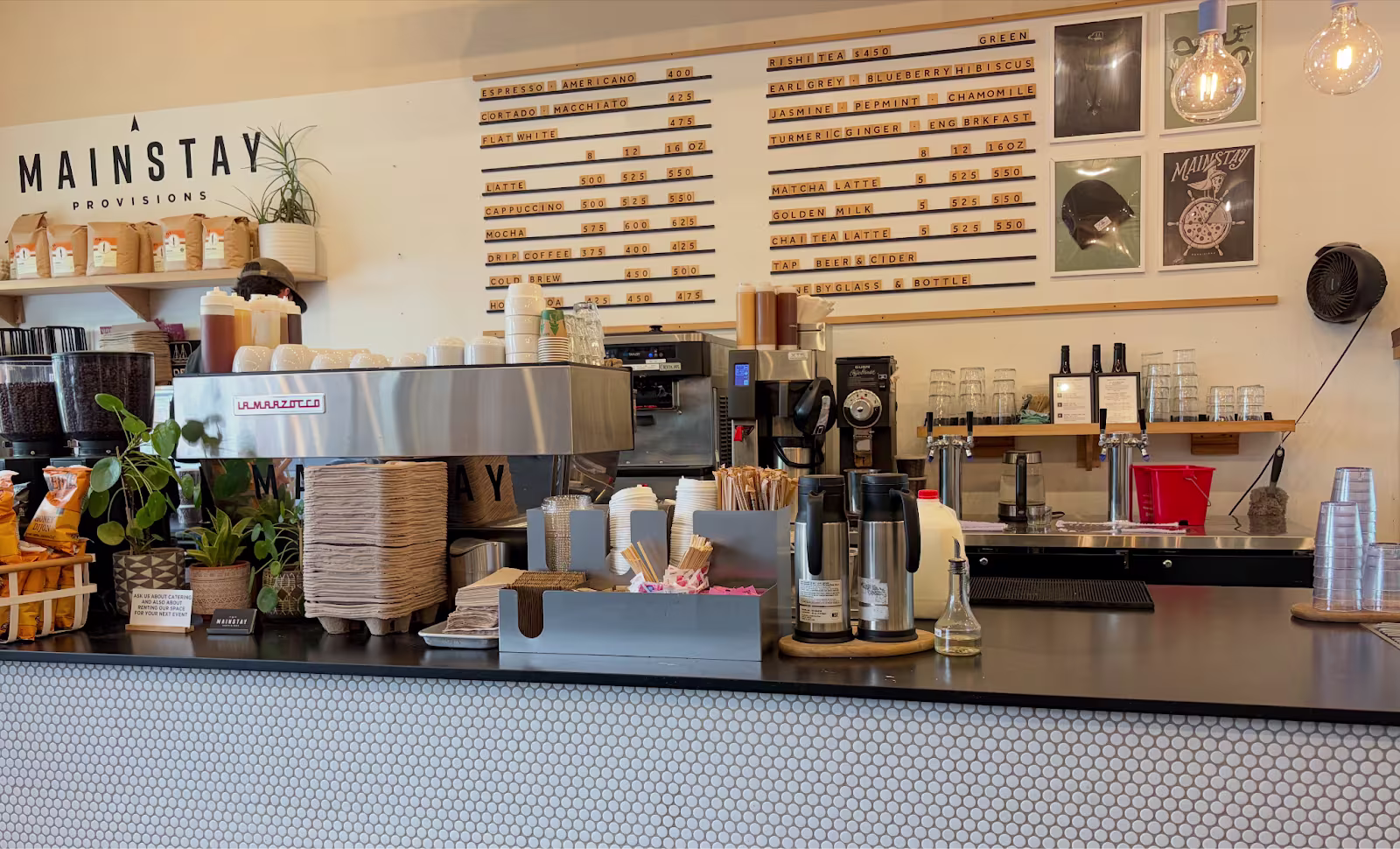 the stocked bar of Mainstay Provisions coffeeshop with menu on the wall