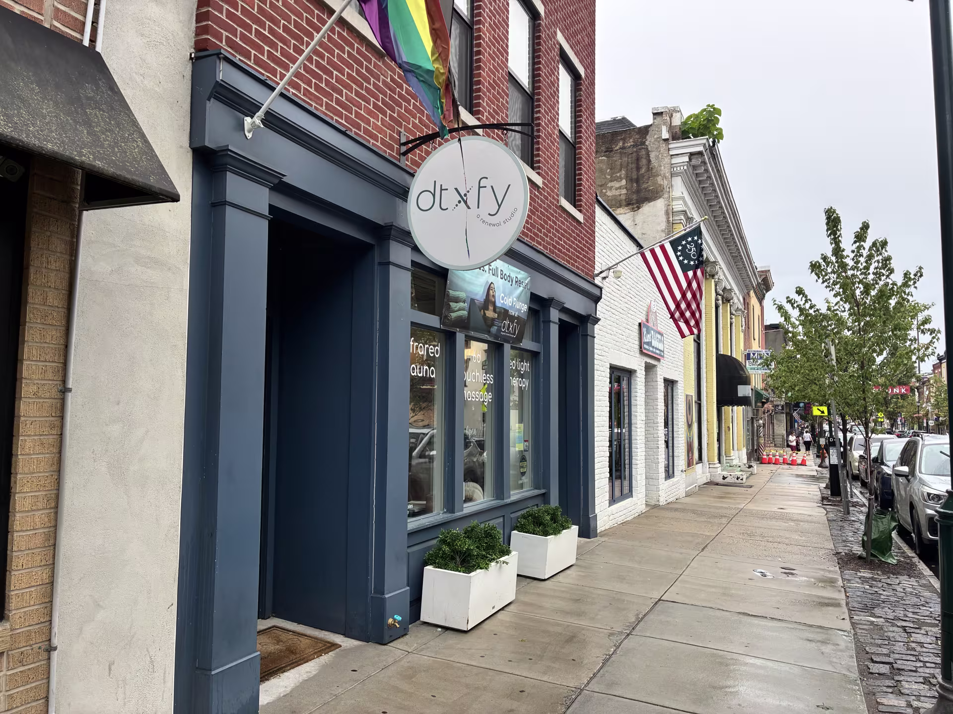 The blue and brick storefront of dtXfy in Manayunk.
