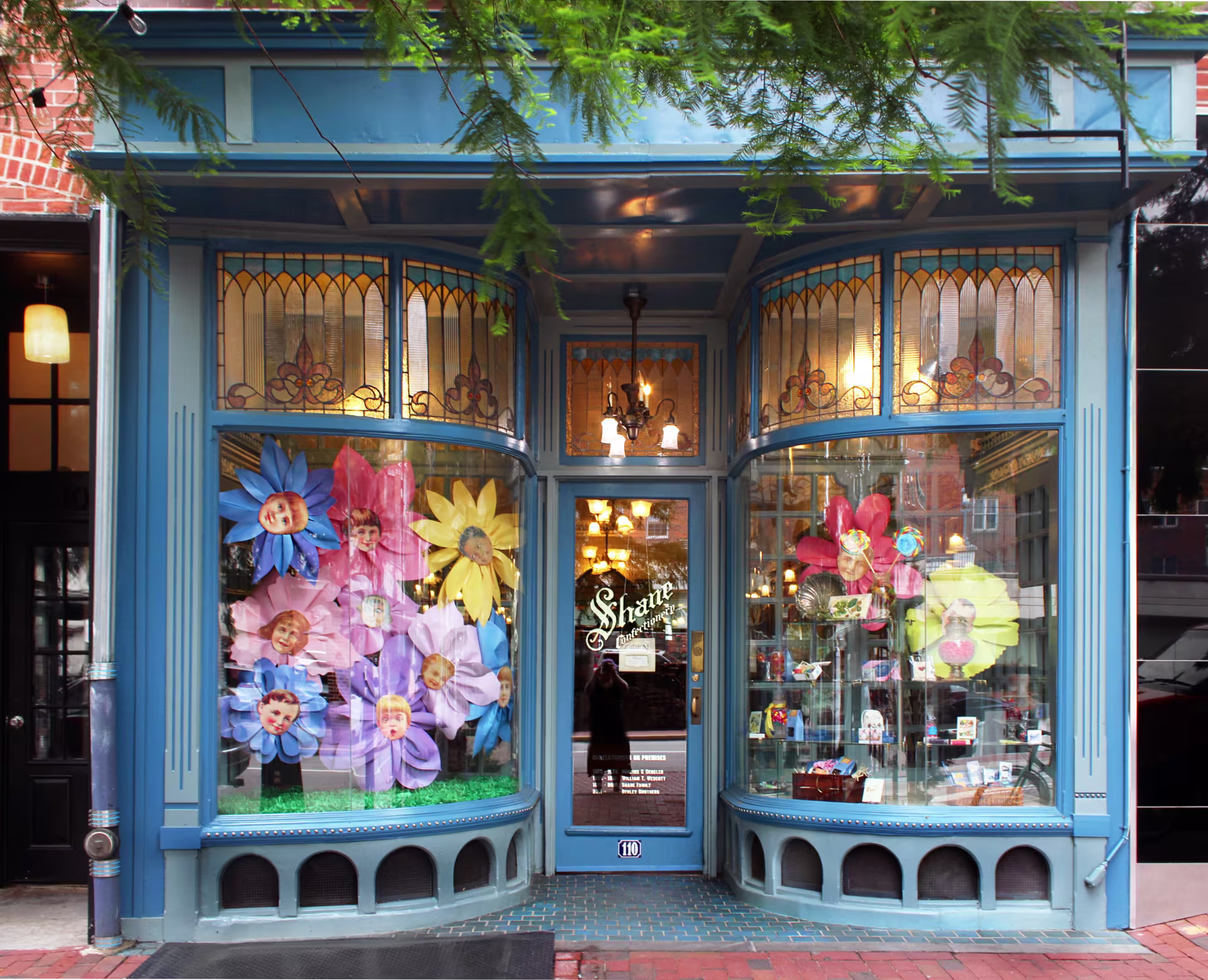 The blue and glass storefront and front door of Shane Confectionery. 
