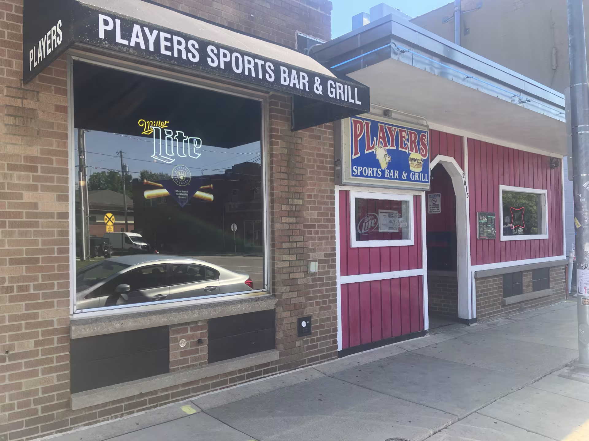 The exterior of a bar with glass windows. 