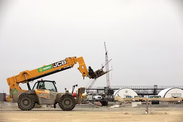 A yellow construction machine in a lot