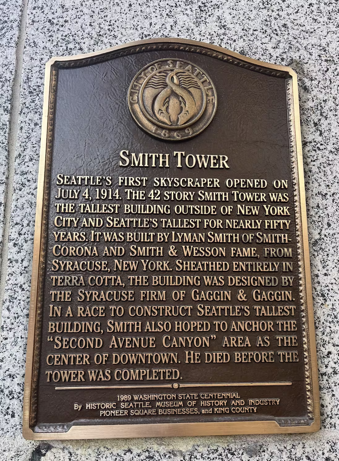 A plaque outside the building which says "the building was designed by the Syracuse firm of Gaggin & Gaggin"