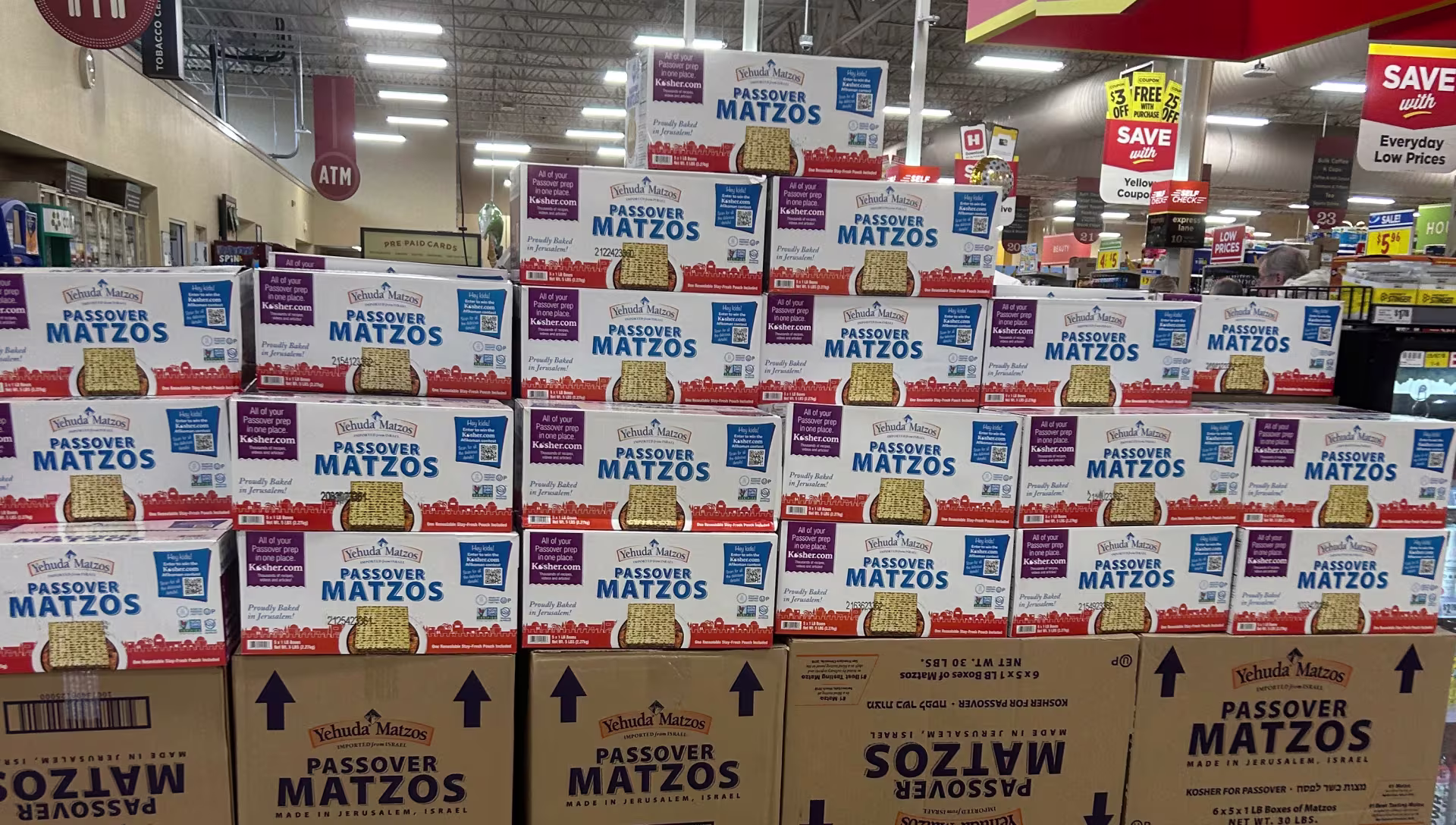 White boxes of matzo stacked on top of each other.