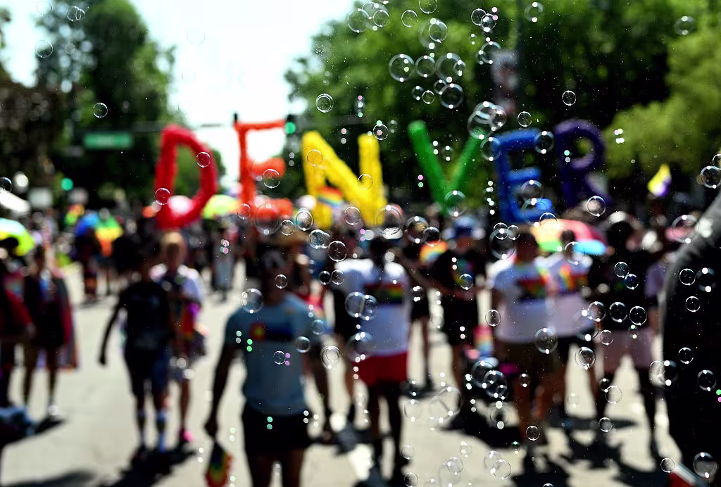 Participants walk in the Denver Pride parade, 2025