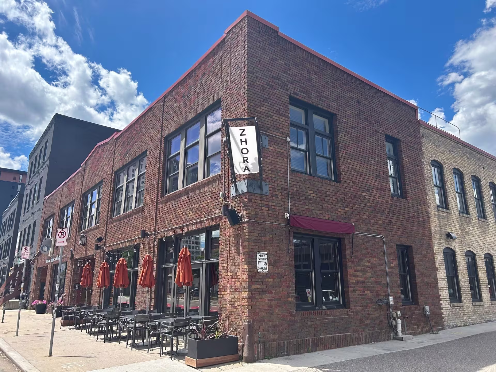 Exterior corner of brick building with restaurant on ground-level