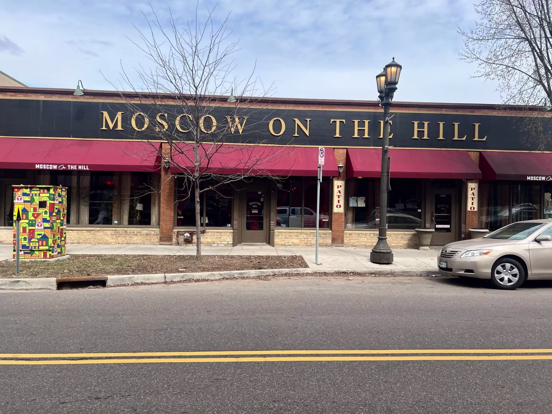 Exterior view of restaurant from urban street, with signage on building that reads, "Moscow on the Hill"