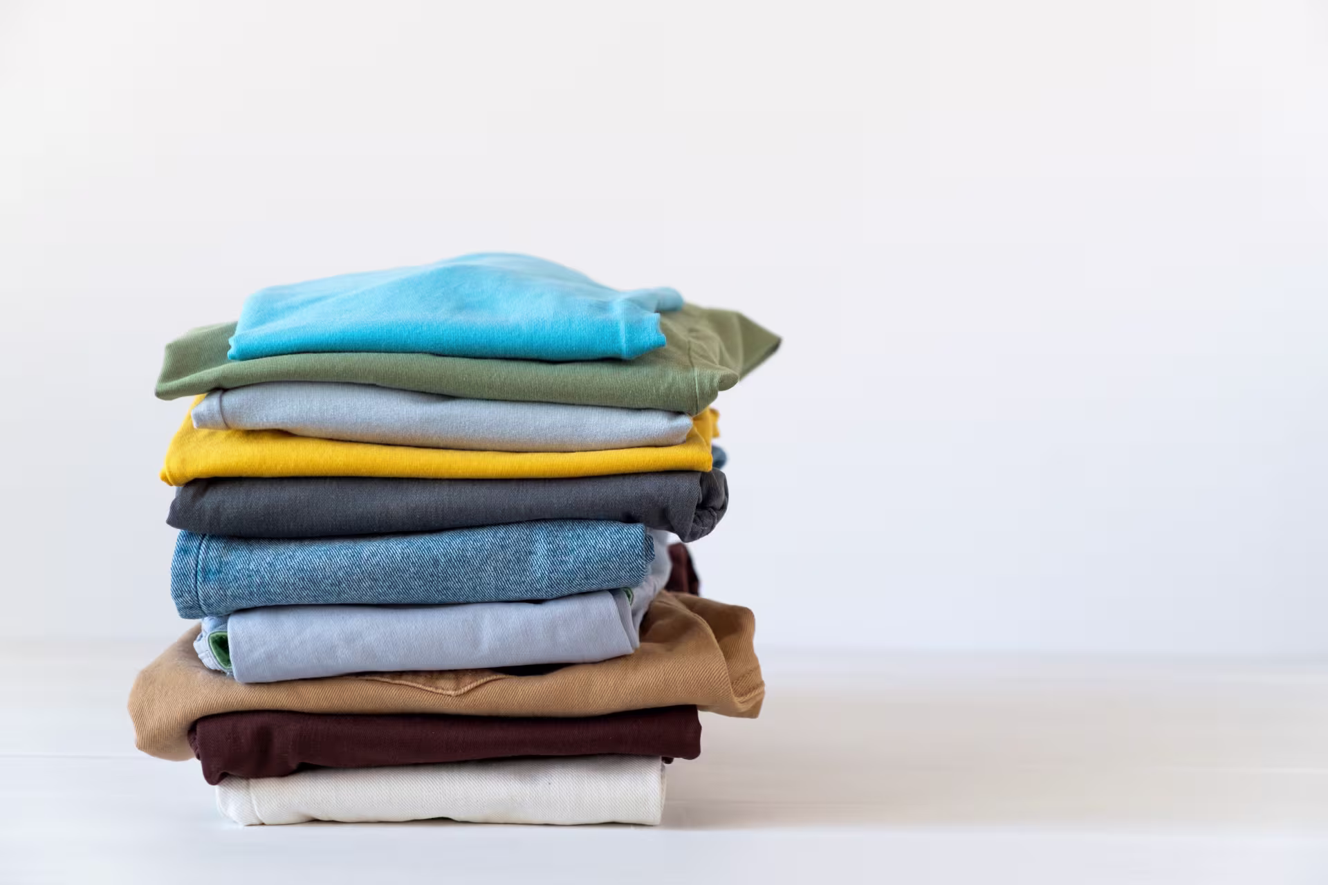 A stack of neatly folded clothes against a white background.