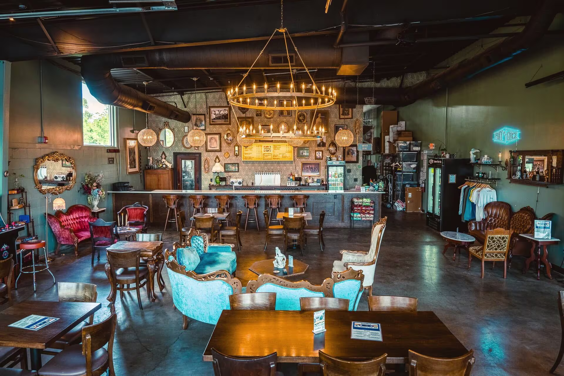 Inside a bar with Victorian couches and wooden tables and chairs.