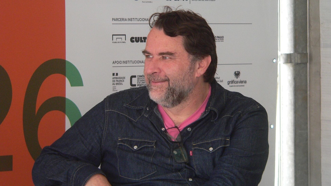 Paulo Werneck, diretor e fundador da revista Quatro Cinco Um, sorrindo durante evento literário.