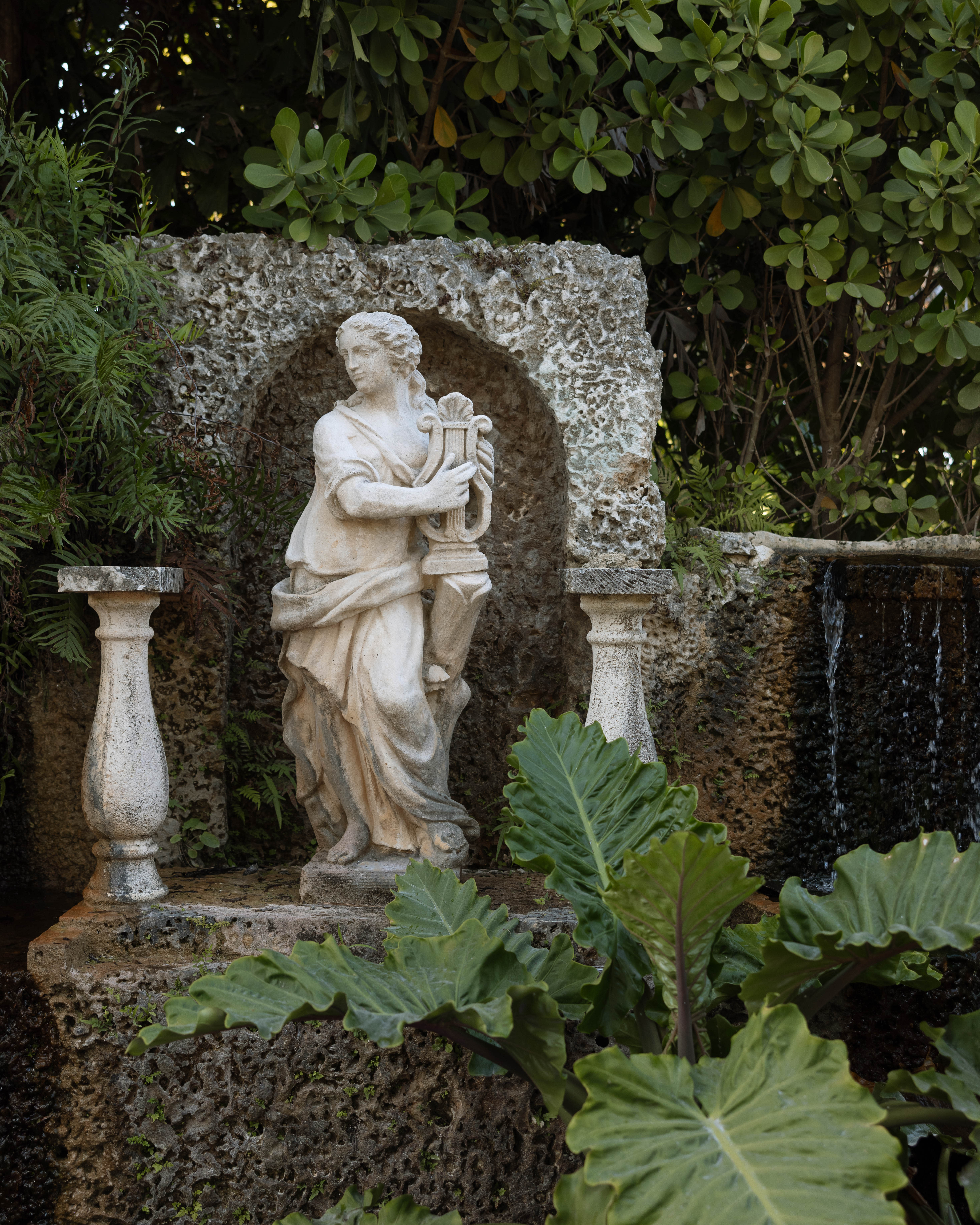 Classical statue in Villa Toscana garden grotto