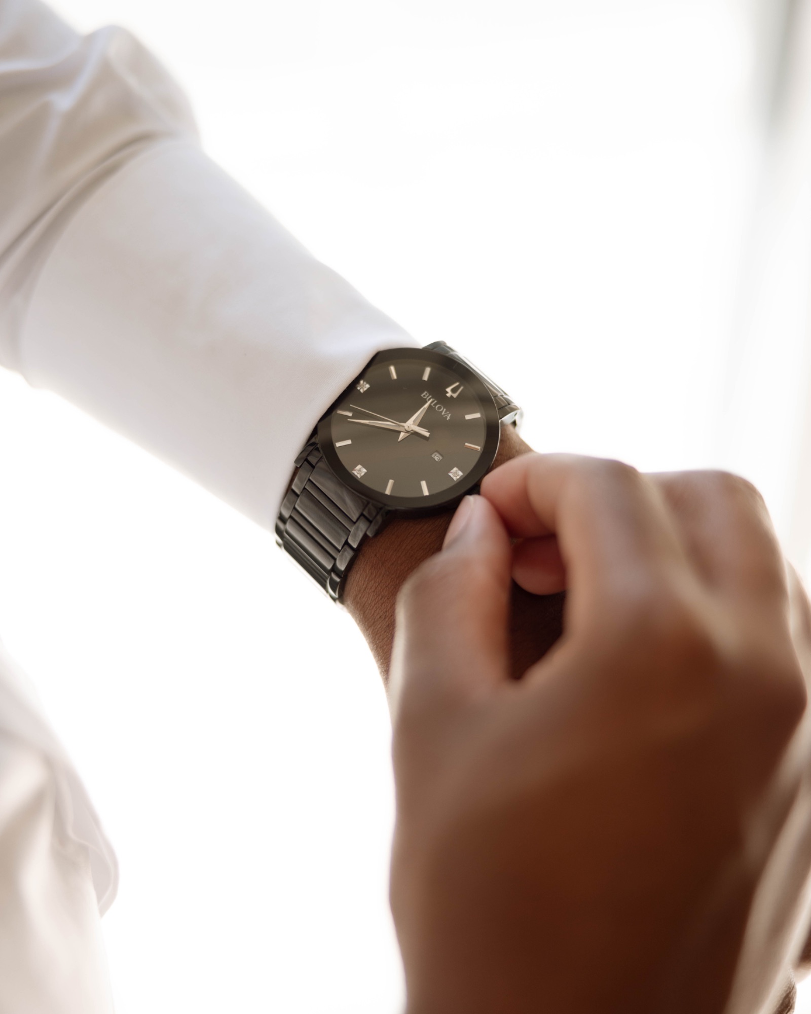 Close on the groom's watch as he sets the time