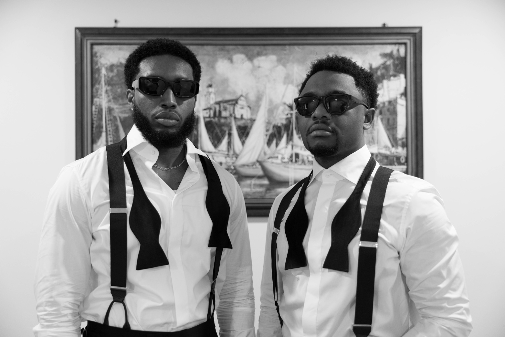 Two groomsmen in sunglasses and suspenders