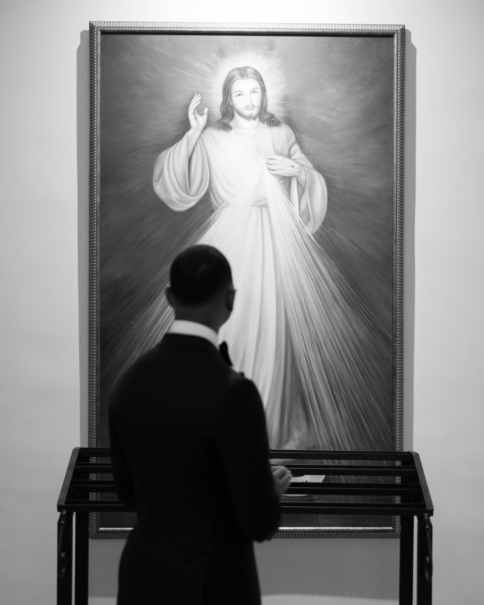 The groom facing the Divine Mercy image before the ceremony
