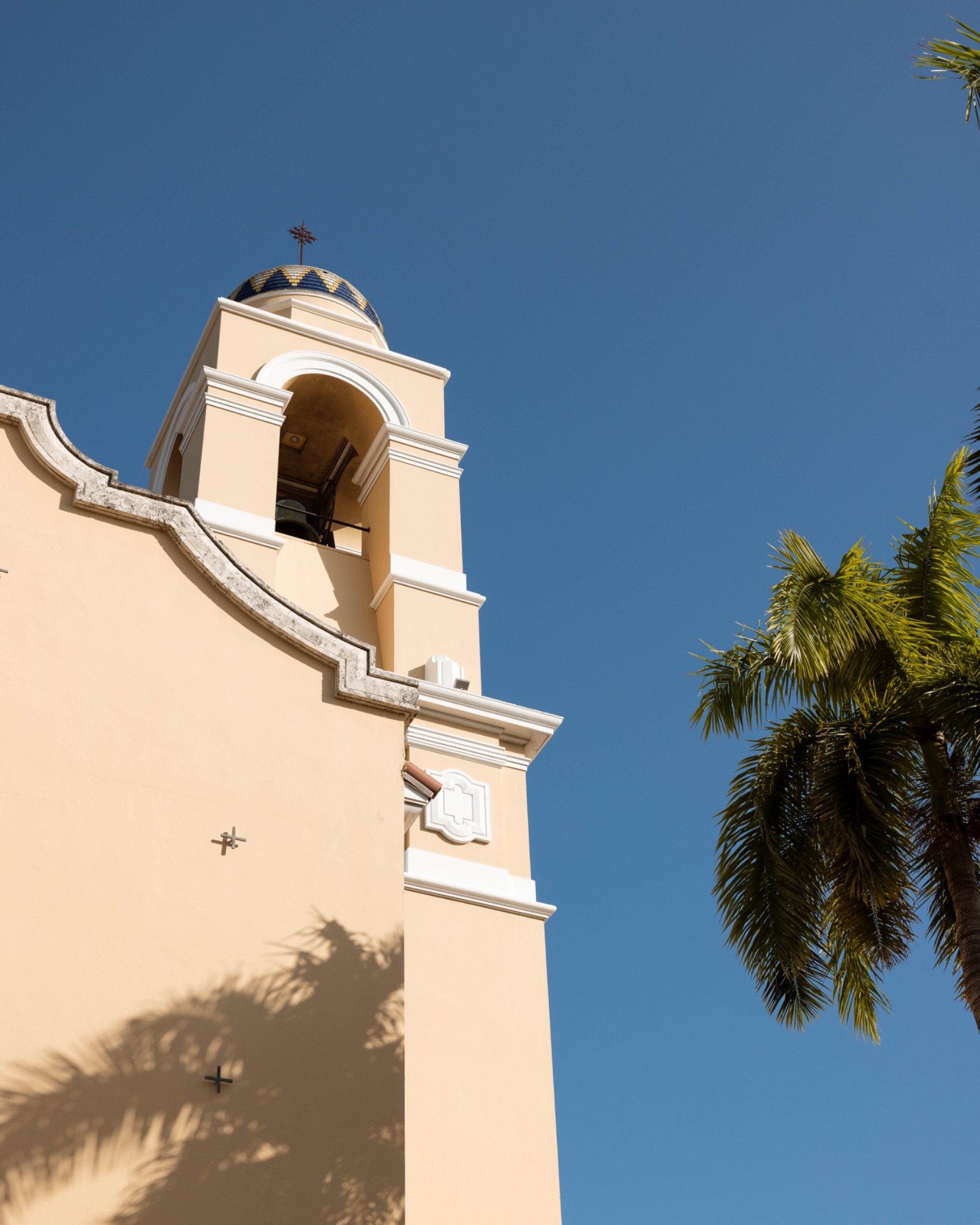 The church bell tower against a clear Miami sky