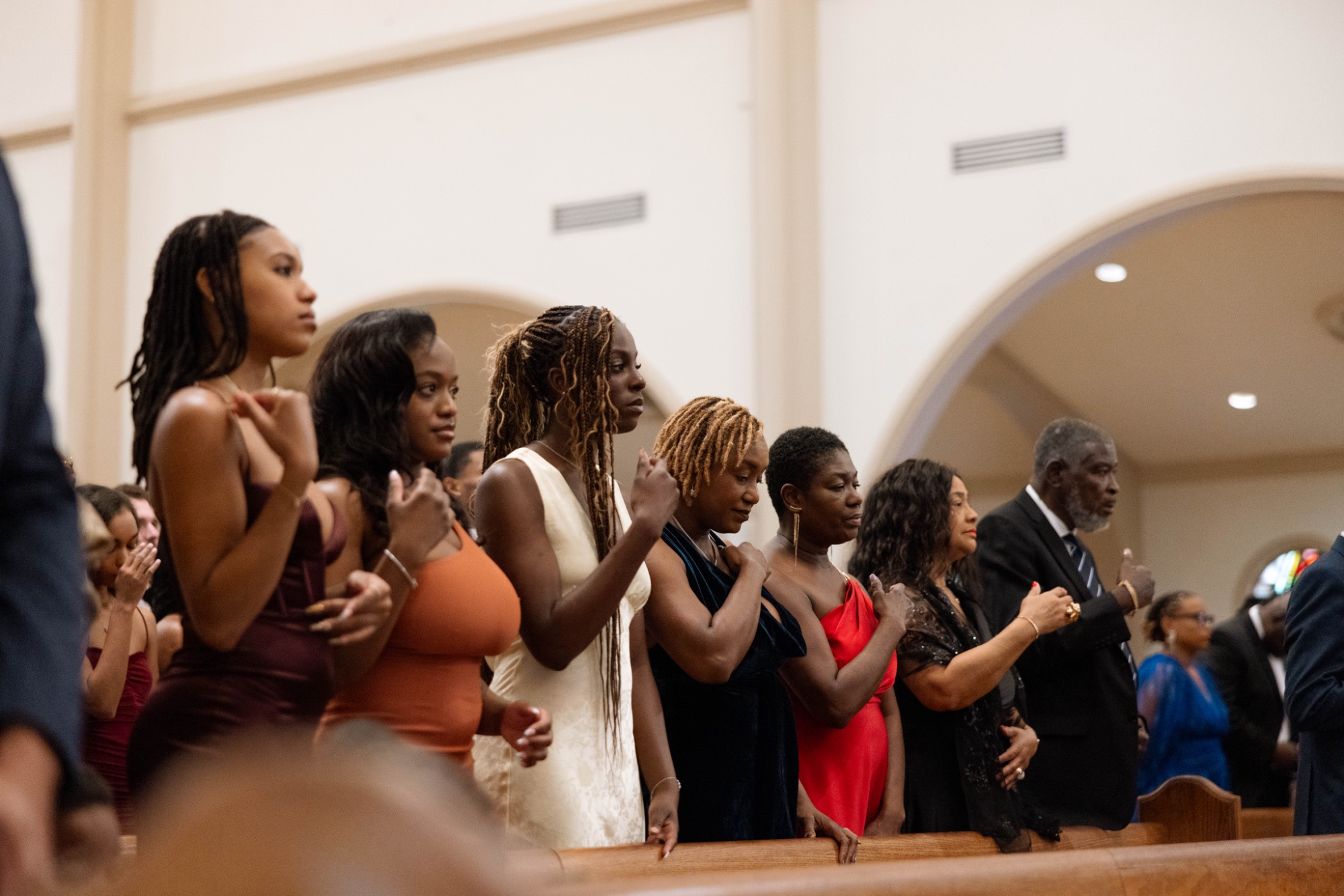 Guests standing through the ceremony