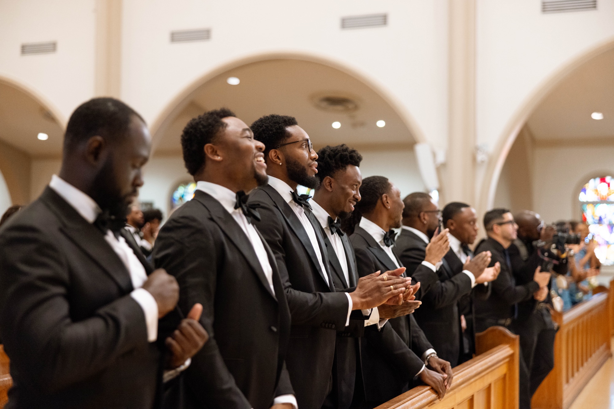 The groomsmen watching from the front pew