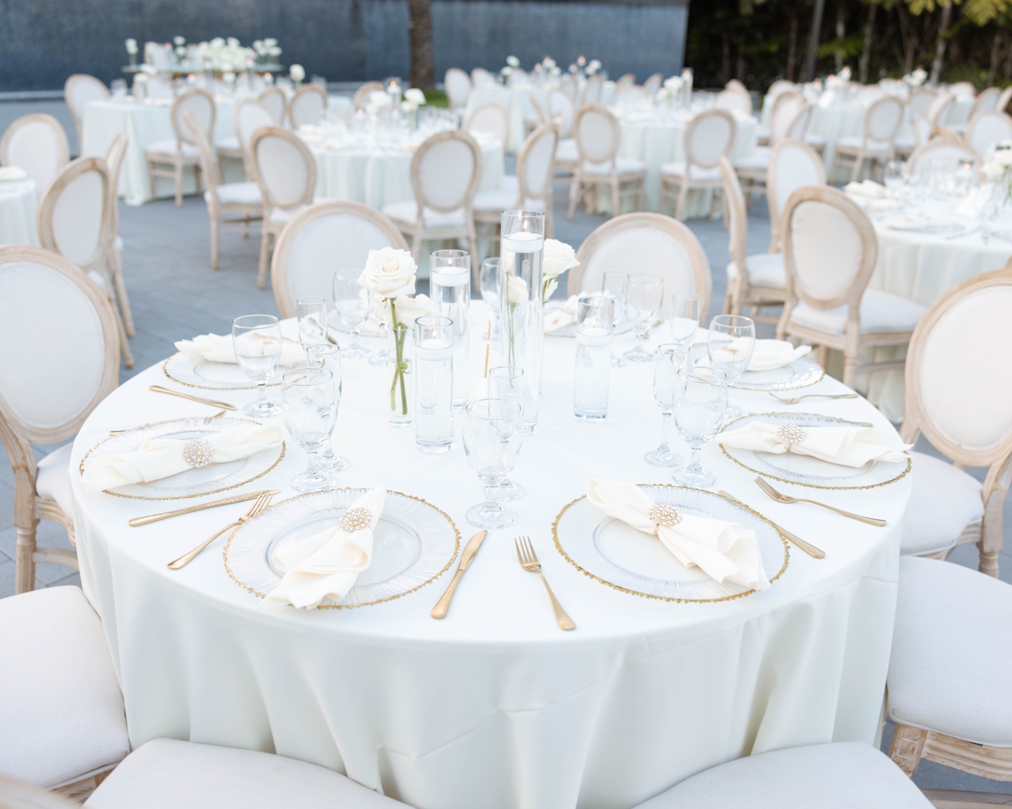 Round tables set in white and gold at The Glass Venue