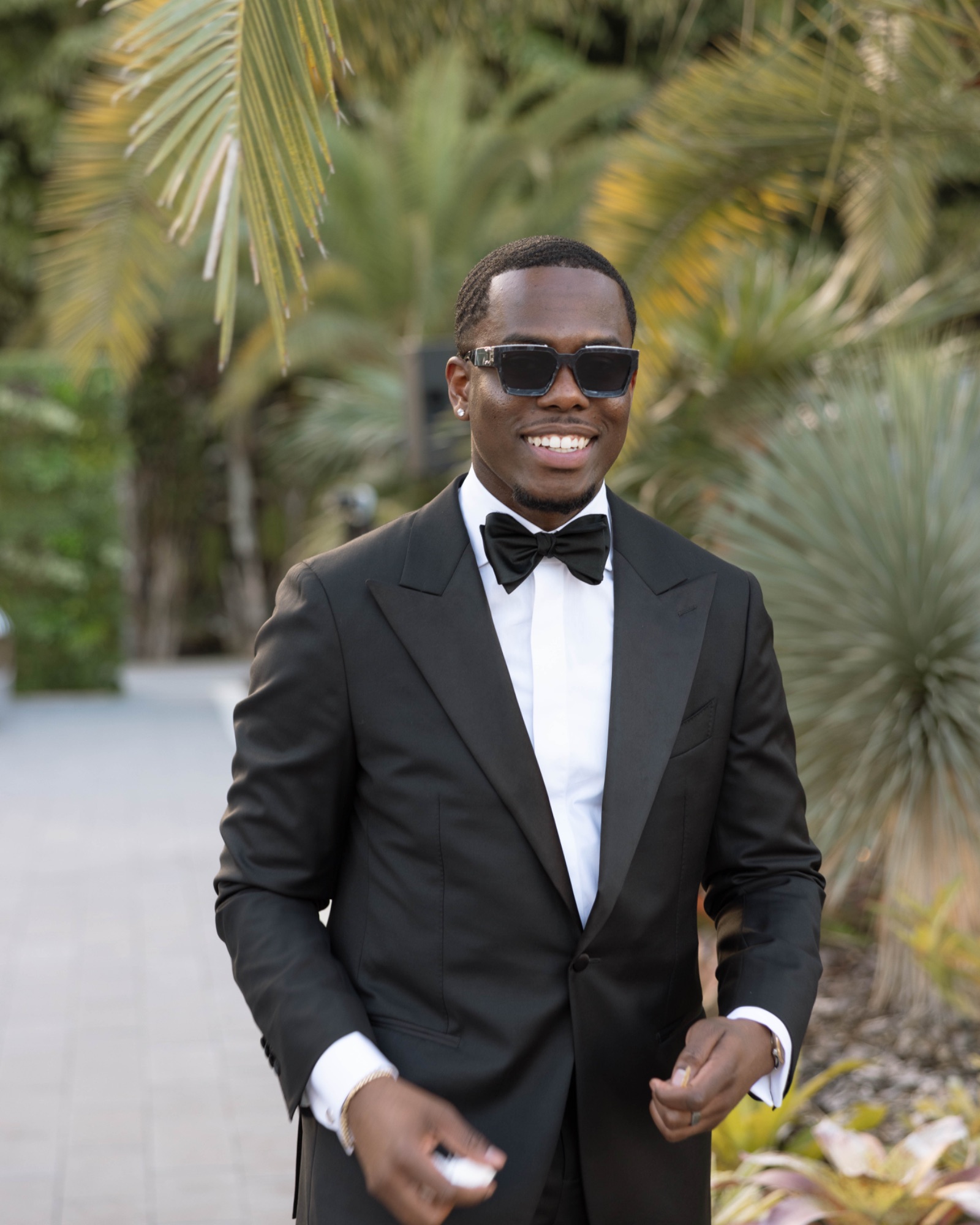 A guest in sunglasses and black tie at cocktail hour