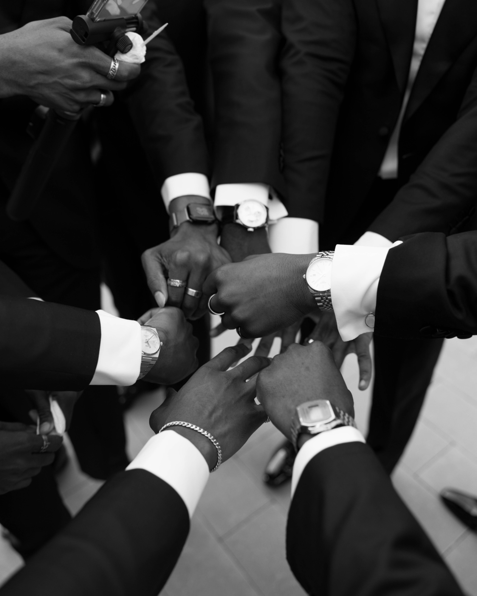 Groomsmen touching glasses, black and white