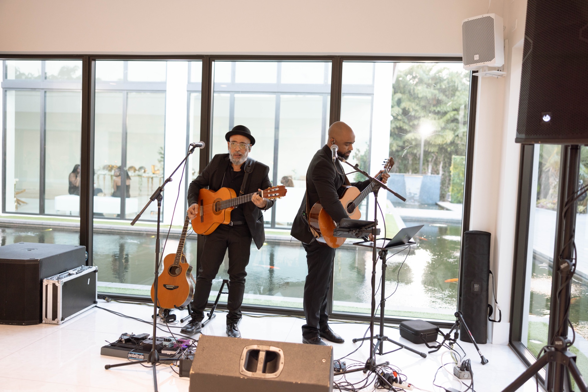 The band playing inside the glass-walled room