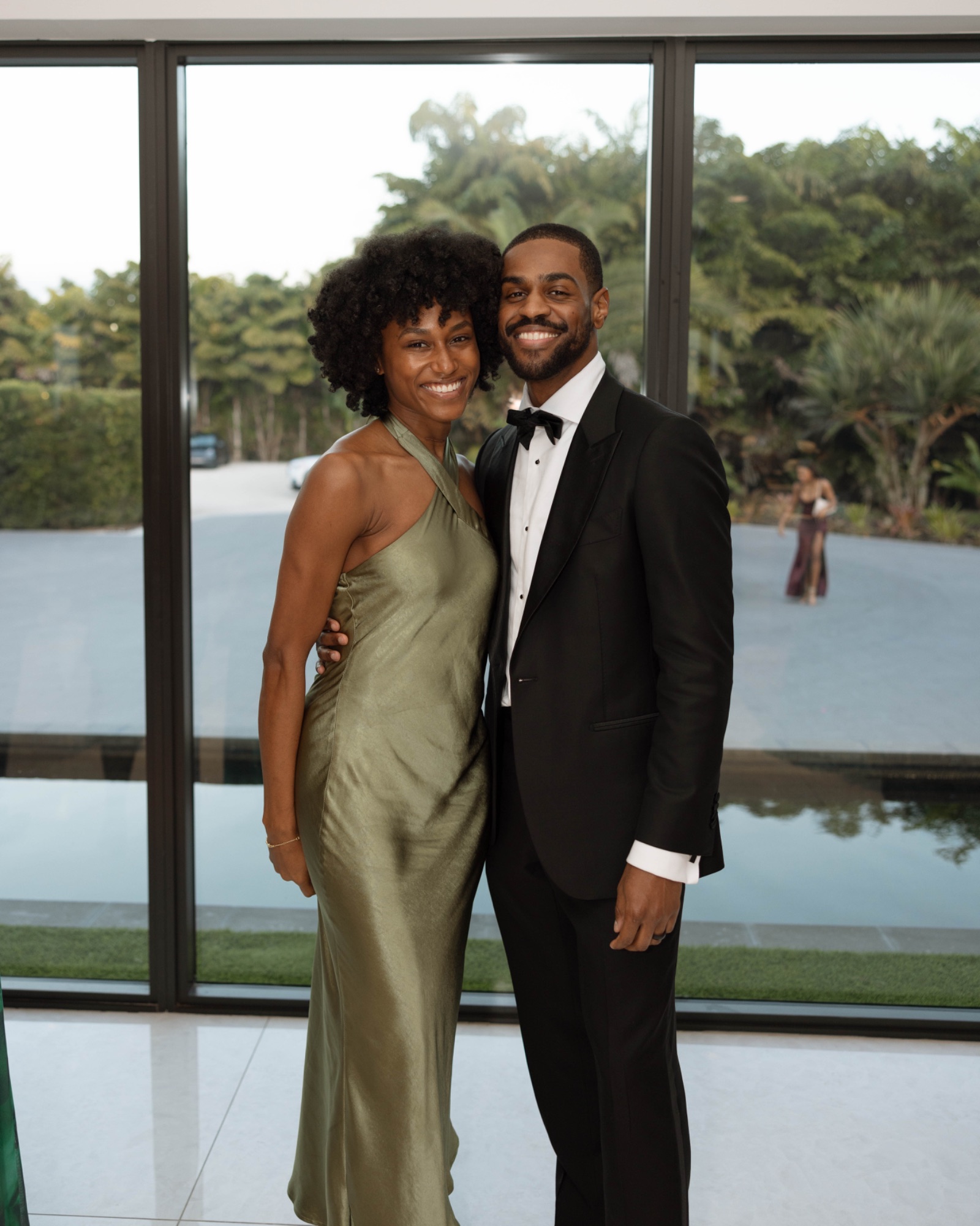 A couple among the guests by the glass wall