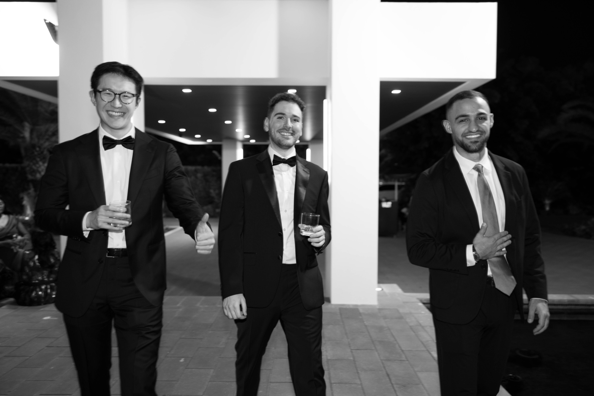 Three guests in black tie, black and white