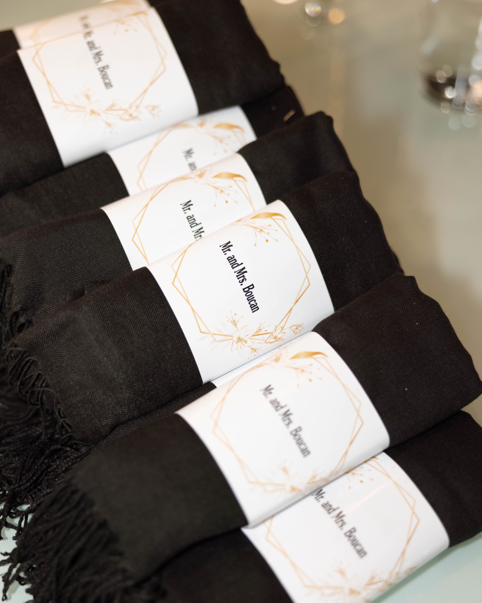 Black wraps folded as favours for the guests