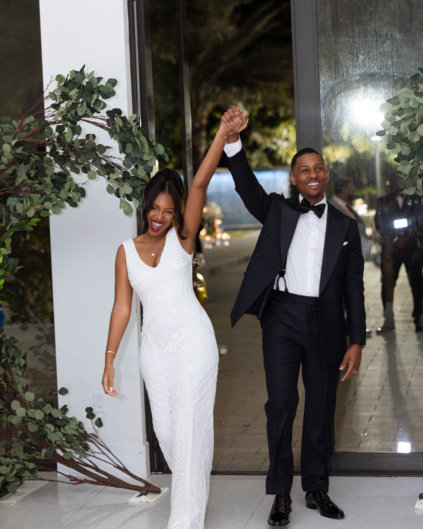 The couple entering the reception hand in hand