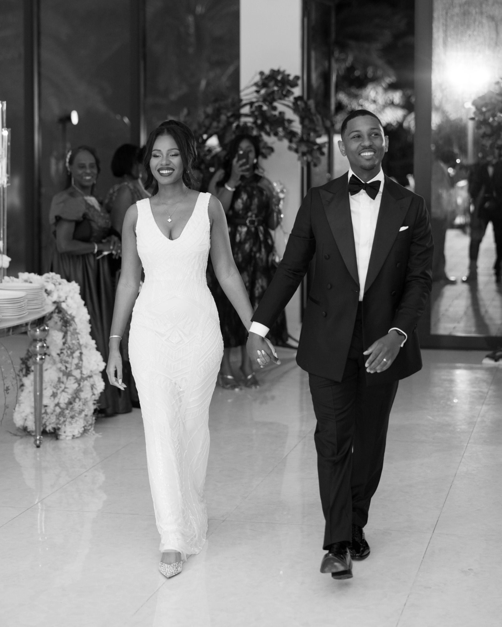 The newlyweds entering the reception, black and white
