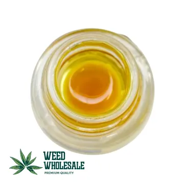 A clear jar filled with golden THC, terpene-rich Sauce