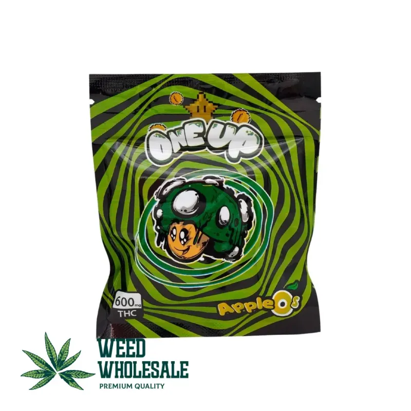 Packaging of One Up Gummies Apples O’s showing green apple ring-shaped candy gummies with a sugar coating and 600MG THC label on the front.