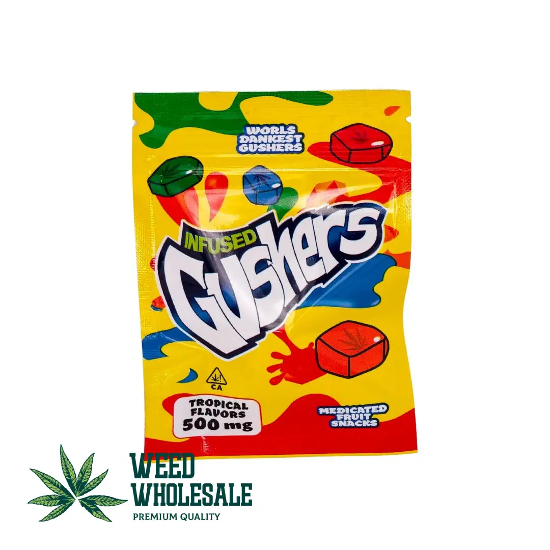 Packaging of Infused Gushers Tropical Flavours gummies featuring colorful tropical fruit-inspired chewy candies with 500MG THC labeling on the front of the pouch.