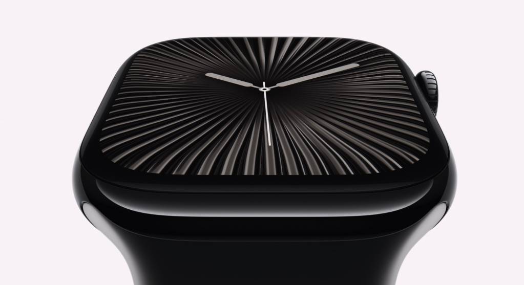 Primer plano de un Apple Watch mostrando su pantalla con un diseño clásico y minimalista, sobre un fondo de tonos neutros y un ligero desenfoque.