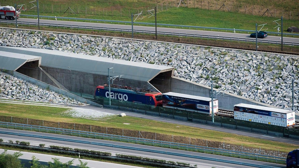 Vista aérea de un túnel de tren atravesando las montañas de los Alpes suizos