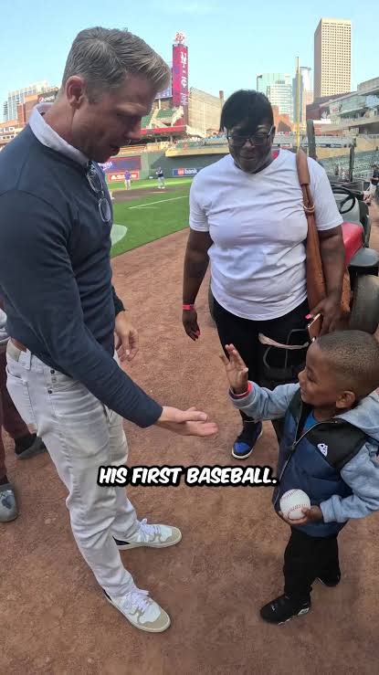 Young fan receiving his first baseball during Josh Liljenquist’s Minnesota Twins community partnership at Target Field.