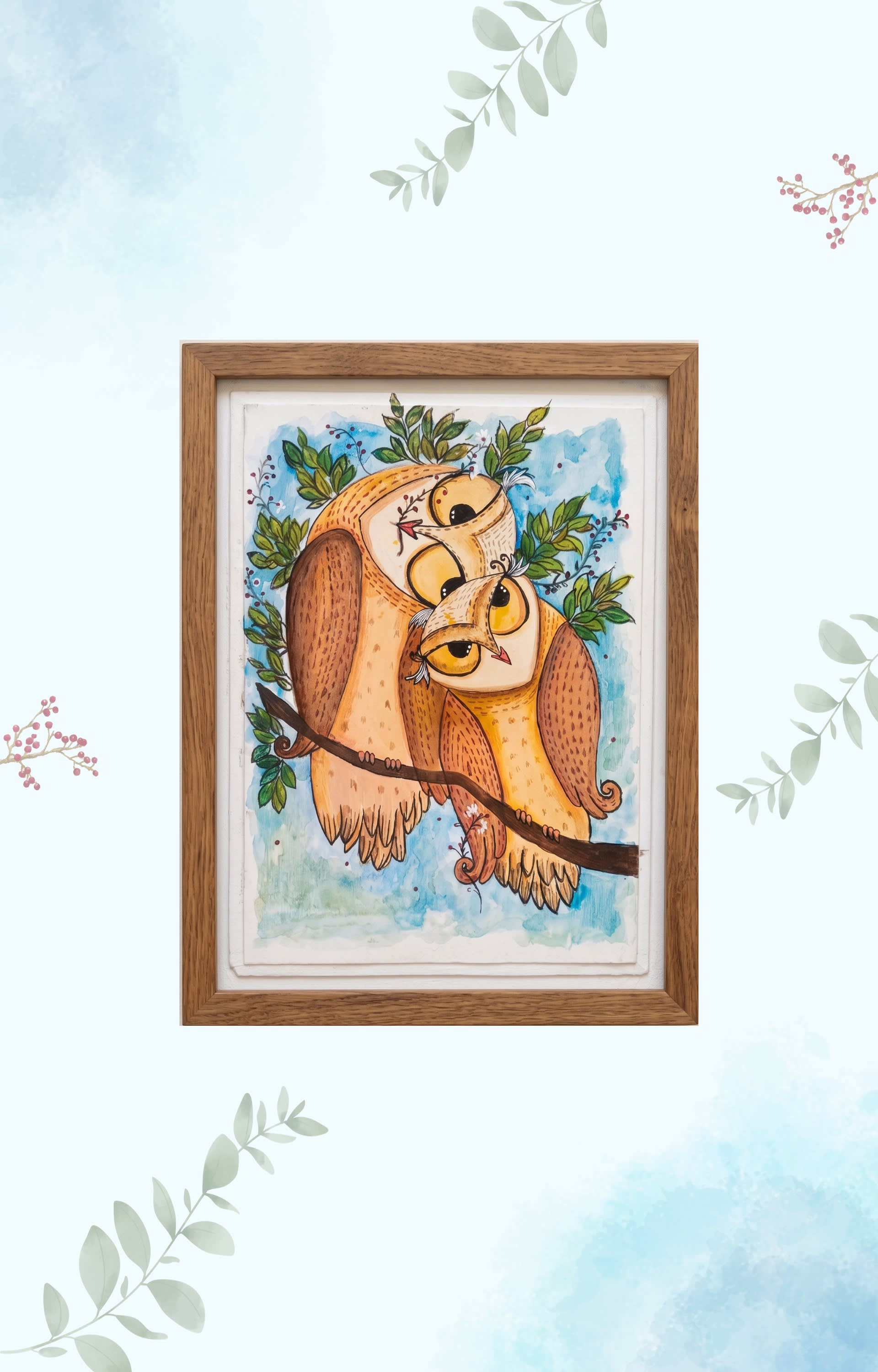 Two cuddled owls on a leafy branch painted in warm yellow and brown watercolors on deckled handmade paper.