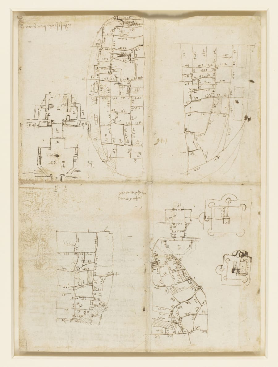 A sheet of rough pen sketches showing several outlines of town street networks with small numbers written along the lines, and two small fortress plans.
