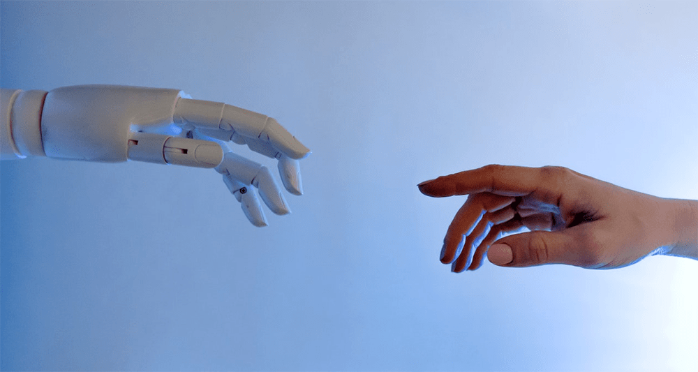 artificial intelligence hand reaching for human hand