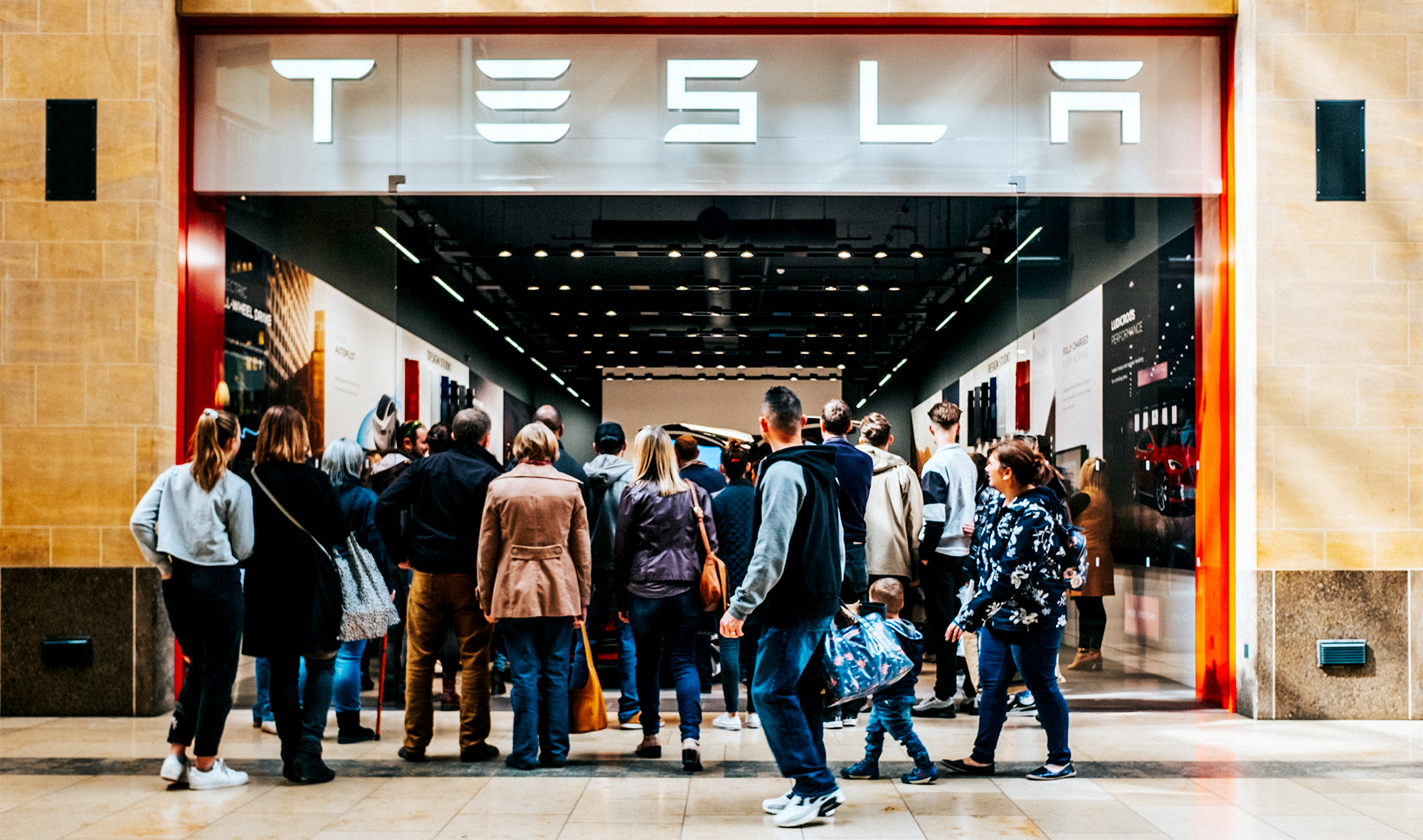 Tesla showroom with shoppers outside the entrance